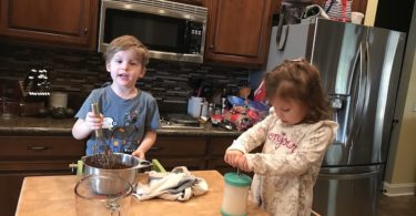 two little kids cooking