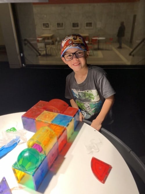 boy playing with magnatiles choose toys