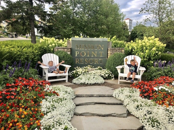 mission point resort kids in chairs and sign