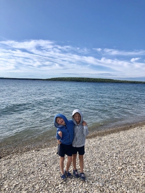 two boys on beach mackinac island lodging