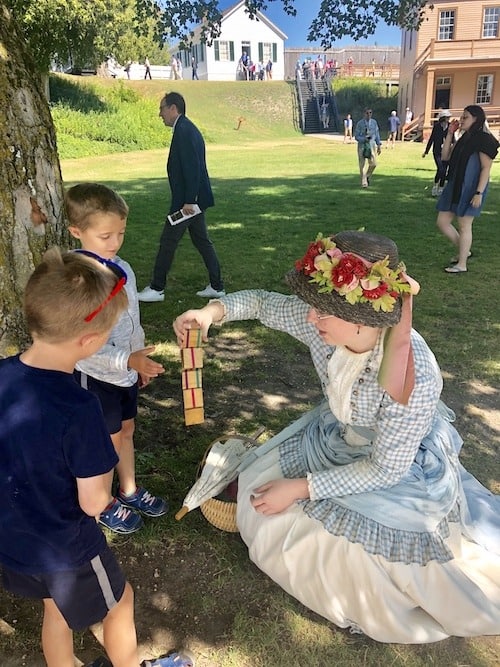 woman showing boys a toy mackinac island lodging