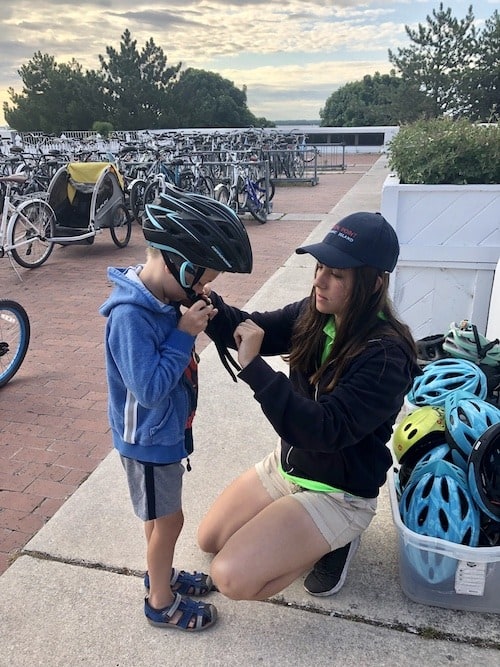 boy putting on bike helmet mackinac island lodging