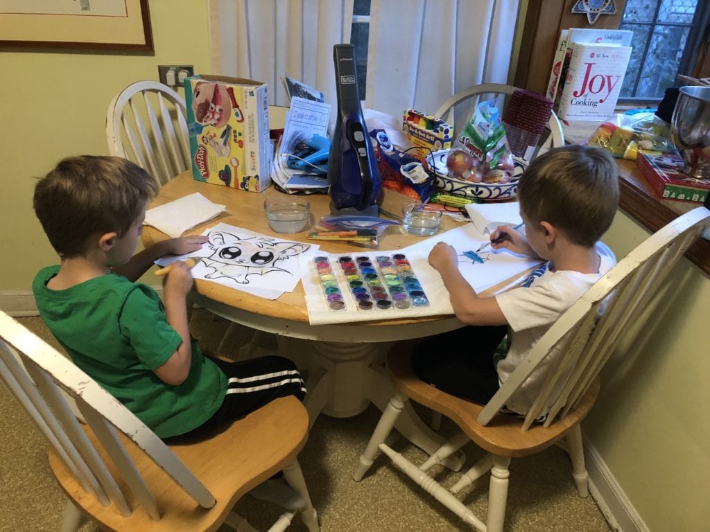 kids painting at a table after school messes