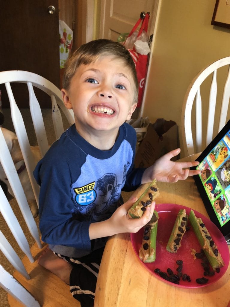 boy eating snack after school messes