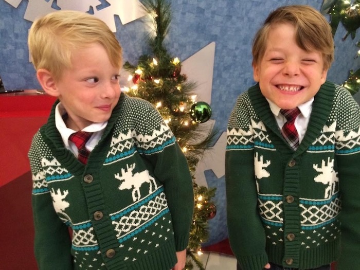 twin boys in christmas sweaters advocate