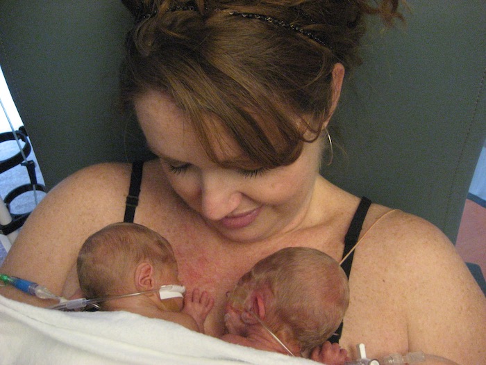 mom holding twin babies in the NICU advocate