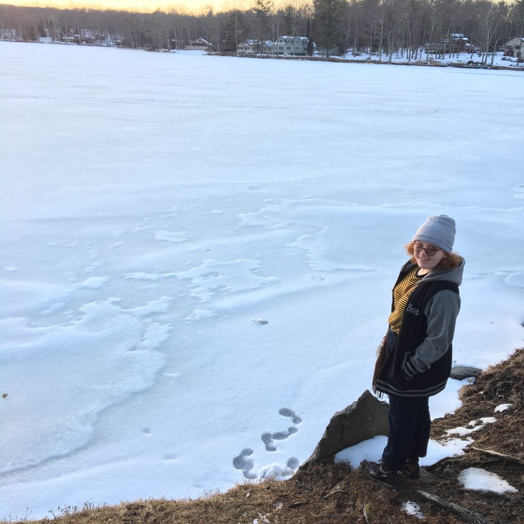 girl standing by lake