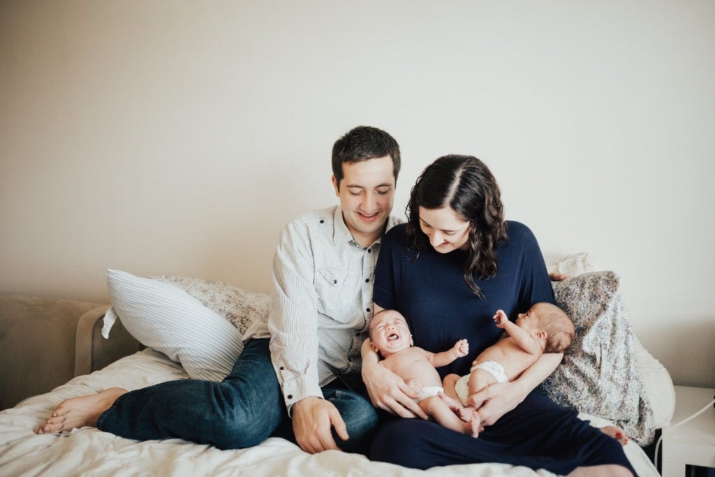 parents holding newborn twins second set of twins