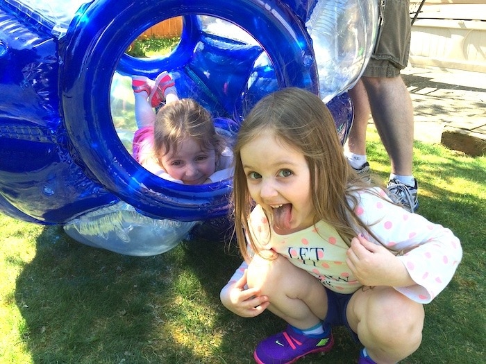 twin girls in backyard three-year-old twins