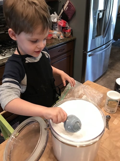 boy scooping flour kids cooking