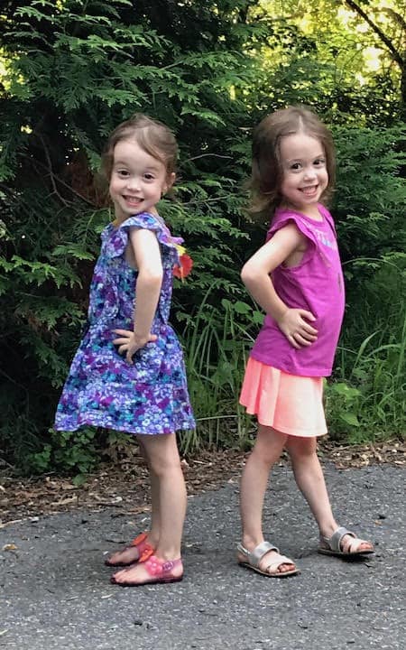 two girls preparing twins for kindergarten