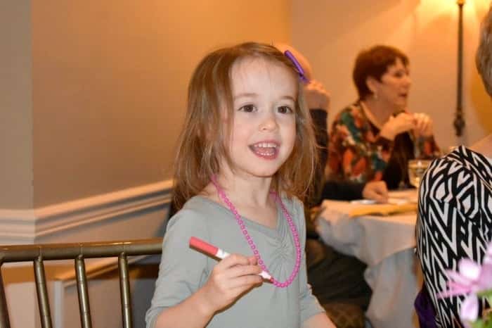 girl writing with marker preparing twins for kindergarten