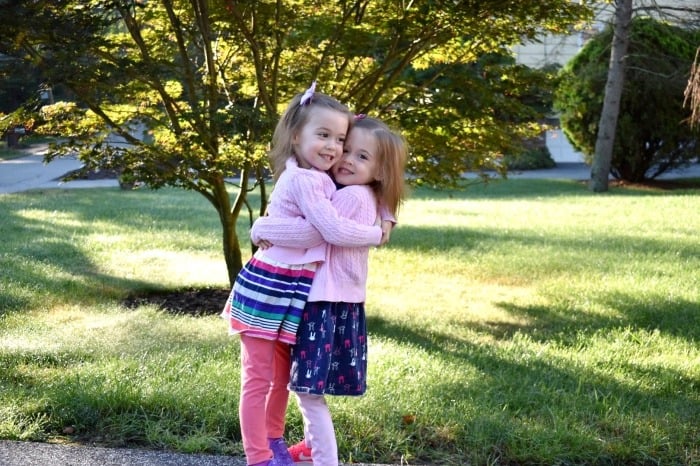 twin girls hugging preparing twins for kindergarten