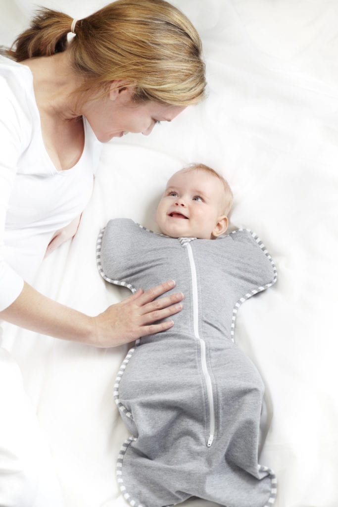 mom and baby in a love to dream swaddle why swaddling helps baby proofing