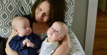 grandma holding baby twins