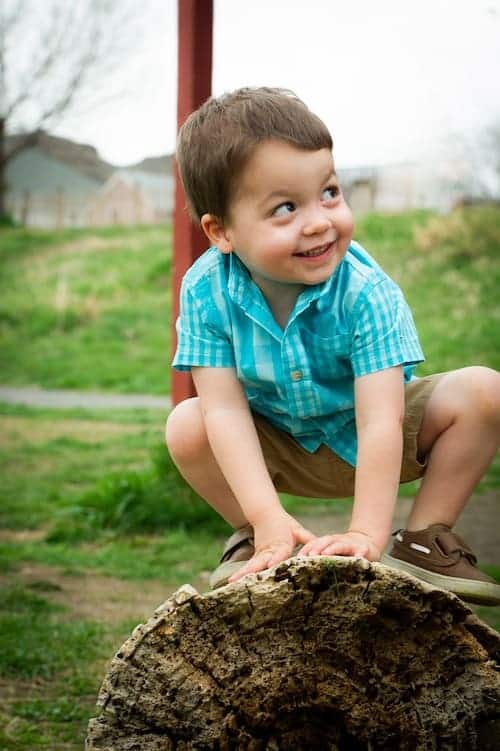 portable oxygen tank boy squating on rock