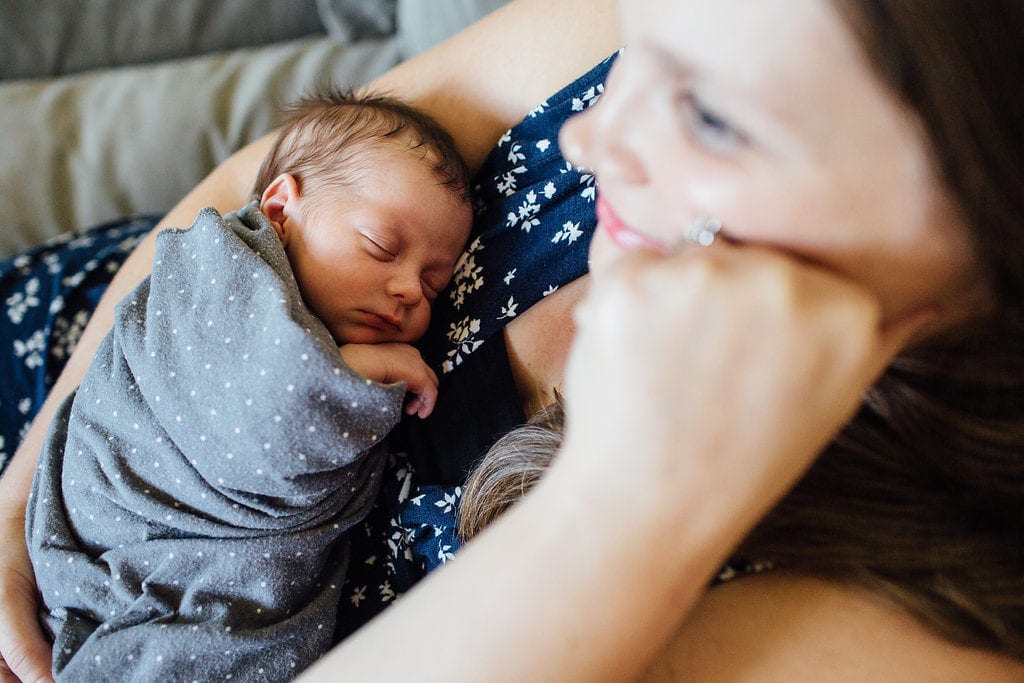 mother holding newborn organization tips