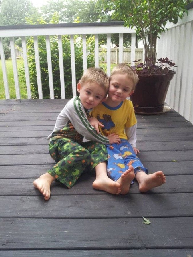 twin boys sitting on porch autism