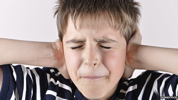 boy holding hands over his ears occupational therapy