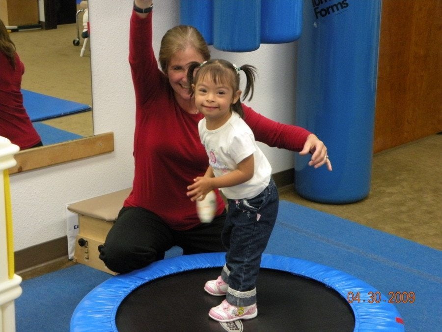 therapist with girl on trampoline occupational therapy