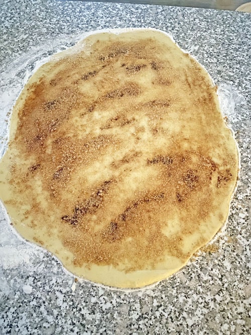 cinnamon rolls dough with filling on top