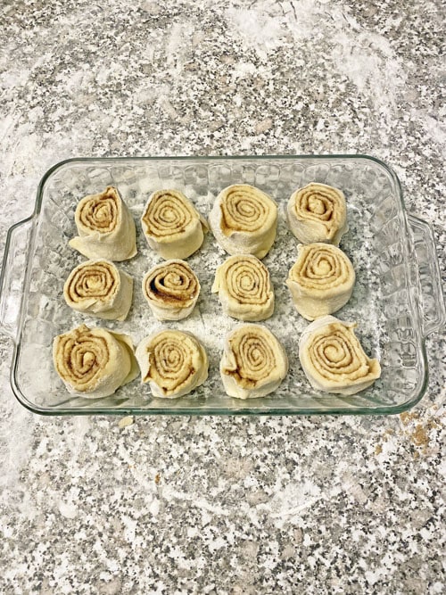cut cinnamon rolls ready to bake in a pan
