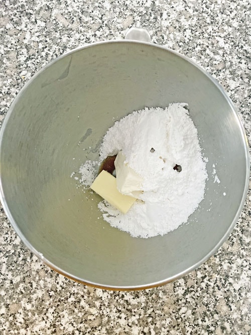 ingredients for cream cheese frosting in a bowl