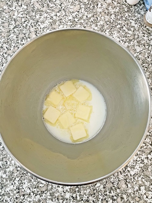 butter in a mixing bowl with milk cinnamon rolls