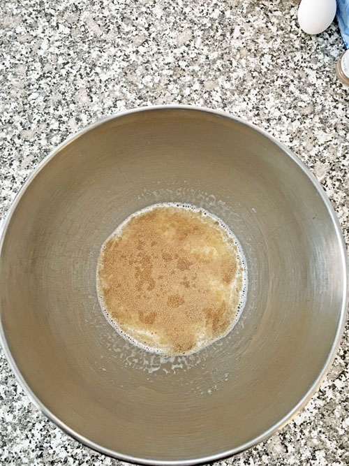 yeast on milk in a mixing bowl cinnamon rolls