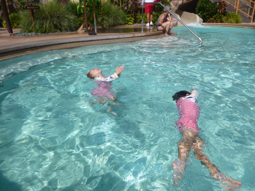 girls swimming in pool disney world with twins