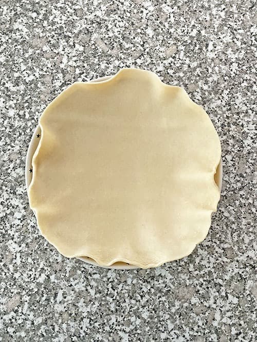 unbaked pie crust in a pie pan pecan pie