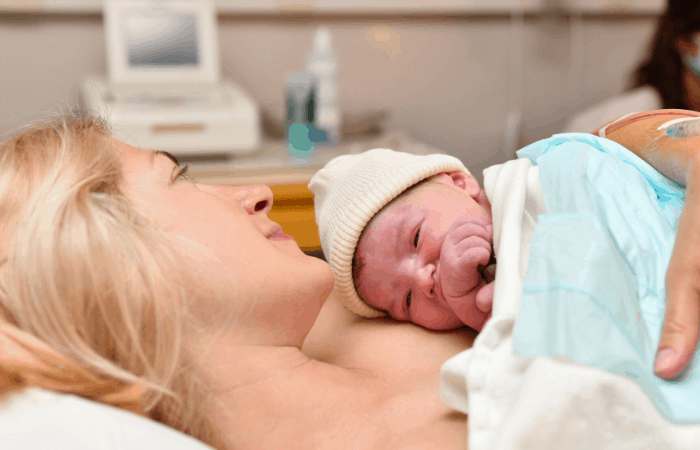 postpartum recovery mom and baby in hospital bed