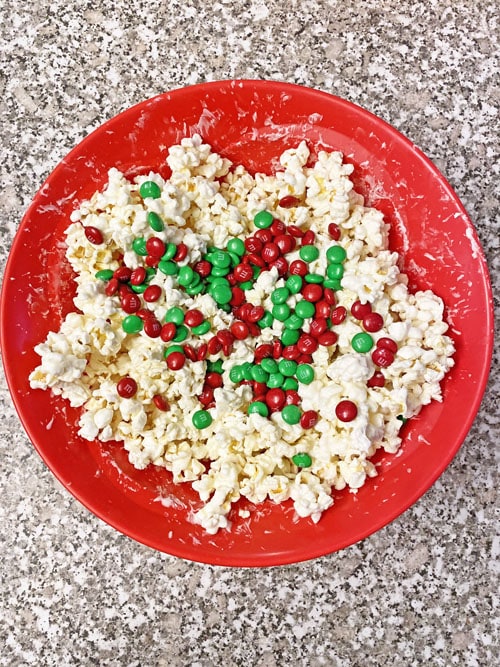 popcorn white chocolate and m&ms in red bowl