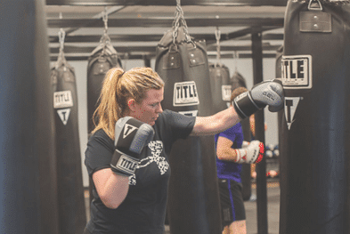 woman hitting a punching bag Reclaiming Yourself After Twins