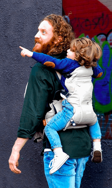 dad carrying toddler on his back babywearing