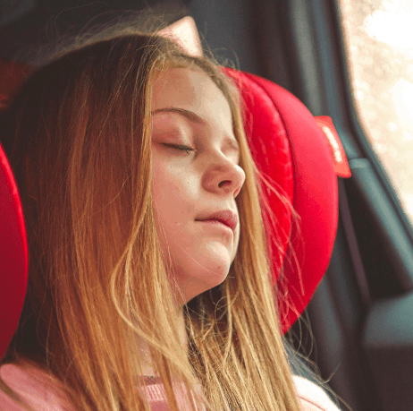 girl asleep in car booster seat