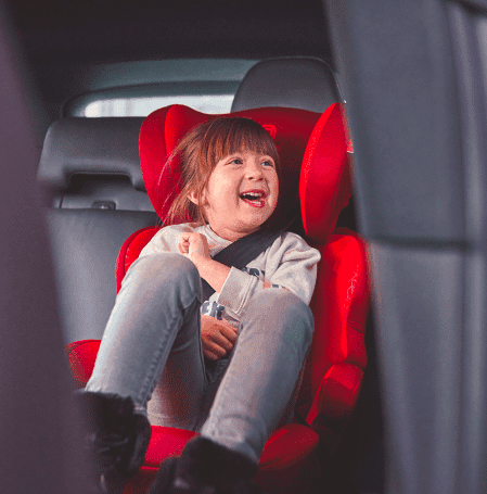 girl in car booster seat