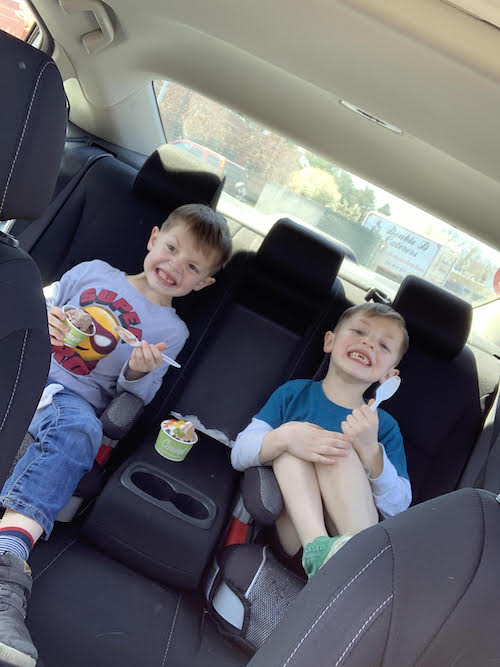 navigating twin boys in back seat of car eating ice cream