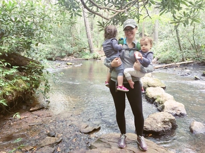 twin toddlers and mom standing by a creek