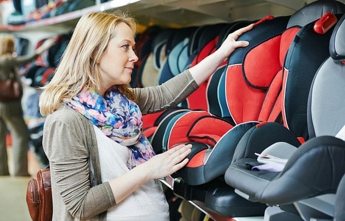 Pregnant woman looking at ar seats