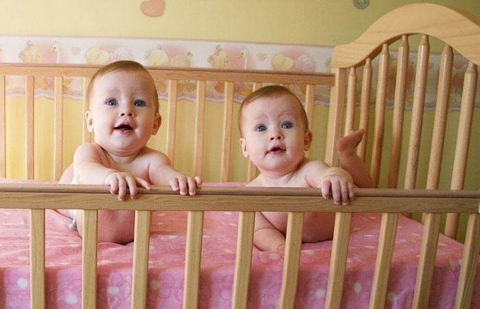 infant twins in crib