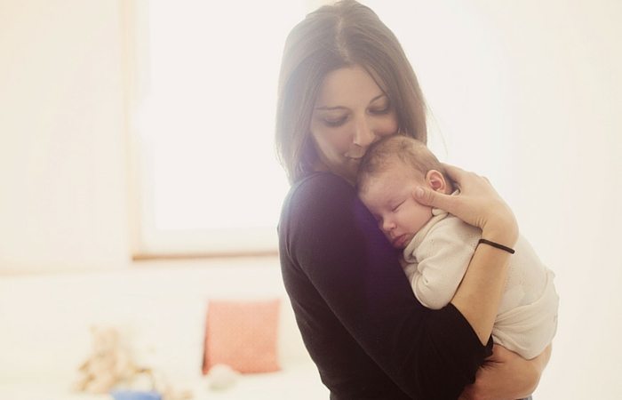 mom holding baby