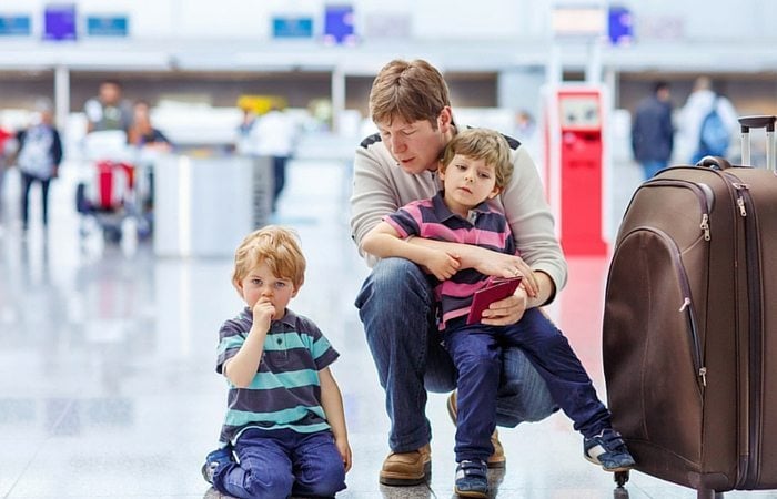 Dad and twin boys in airport