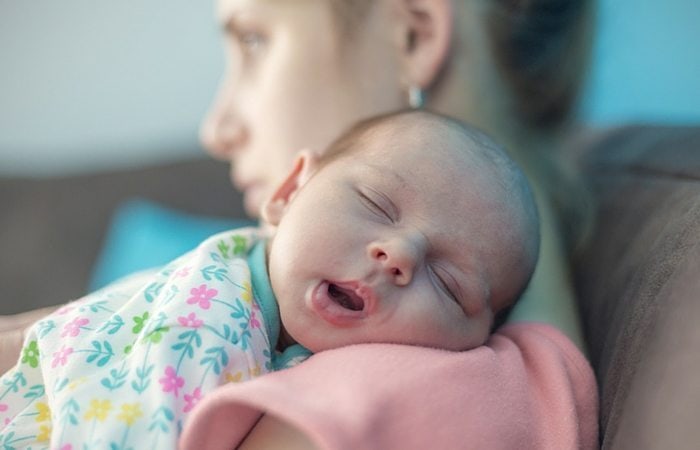 baby sleeping on mom's shoulder