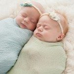 Newborn twin girls in blankets