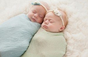 Newborn twin girls in blankets