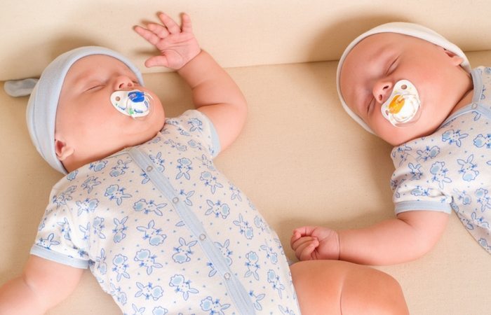 infant twins sleeping with pacifiers