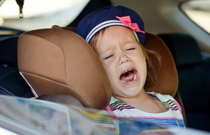 toddler girl crying in car seat