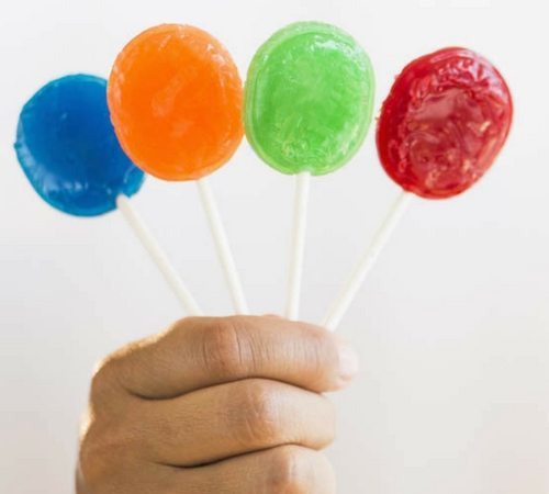 hand holding lollipops