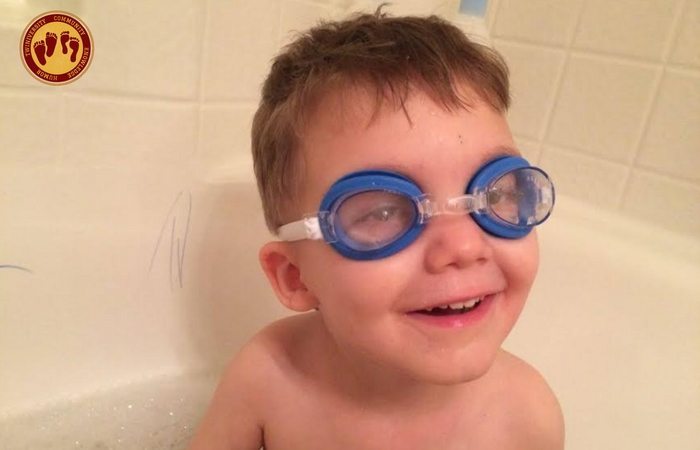 boy in bathtub with goggles on